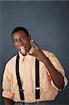 Young African-American male gestures approval with tongue sticking out