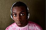 Serious young African-American in pink tie-dye and headphones