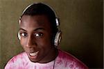 Good-looking young African-American in pink tie-dye and large headphones