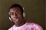 Young African-American male smiles while listening to something on his headphones