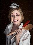 Grinning gorgeous Caucasian lady holding spatulas
