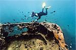 Diver exploring shipwreck underwater. Gunboat at Lusong Island