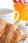Breakfast with coffee marmalade and croissants on a white background