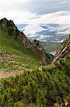 a mountain valley with clouds in background