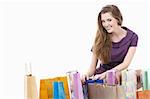 Attractive girl with shopping bags on white background