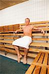 Portrait of a happy man sitting in a sauna