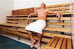 An attractive caucasian man relaxing in a sauna