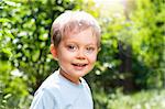 Cute 2 years old boy outdoors at sunny summer day