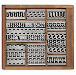 numbers and ornaments - vintage metal printing blocks in wood retro typesetter box, isolated on white