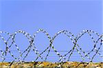 Barbed wire on a background of blue sky