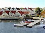 Little houses on a river with marina in front, Norway