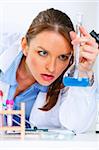 Pensive doctor woman in laboratory analyzing results of medical test