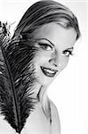 b/w Portrait of sexy fashion woman with red lips in black dress with bird feather. white background