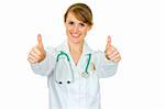Smiling medical doctor woman showing thumbs up gesture isolated on white