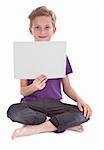 boy sitting and holding a blank white page with copyspace for your text