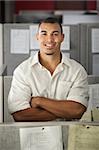 Confident Black male office worker with his arms folded