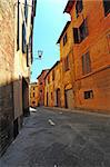 Narrow Alley With Old Buildings In Italian City of Siena