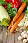 Fresh garden vegetables on an old wooden board.