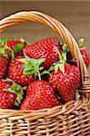 Fresh strawberries in a wicker basket close-up.