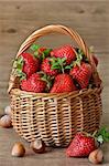 Fresh strawberries with leaves of mint on a wicker basket.
