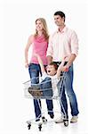 Young couple in a cart driven by his son on a white background