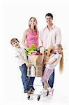 A happy family with a cart with food on a white background