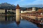 The Chapel Bridge and Lake Lucerne, in the city of Lucerne, Switzerland.  Photo taken early in the morning as the sun starts to rise.