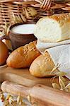 Tasty fresh bread with sesame and cup of milk.