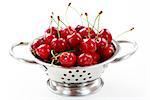 Fresh cherries in the bowl on white background
