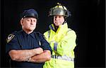 Fire fighter and police officer on black background with copyspace.
