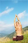 Young man is occupied yogi on the mountain