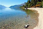 View of the clear waters and mountains at lake Wakatipu, New Zealand