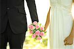 Outdoor Bride and Groom holding flower bouquet
