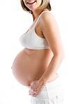 Pregnant woman with exposed belly smiling