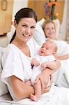 New mother with baby in hospital smiling