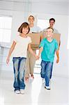 Family with boxes moving into new home smiling