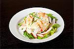 Salad of shrimps, crab meat, cucumbers, apples, potatoes, lettuce, maize, eggs and mayonnaise