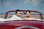 boyfriend and girlfriend sitting in vintage car and hugging in havana, cuba. Horizontal shape, side view, copy space