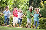 Five young friends running outdoors smiling