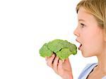 Young girl eating broccoli