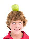 Young boy with apple on his head smiling