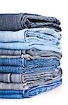 stack of various jeans isolated on white background