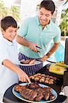 Father And Son Barbequing