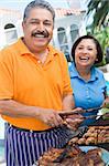 Couple Cooking On A Barbeque