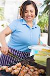 Woman Cooking On A Barbeque