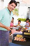 Family Enjoying A Barbeque