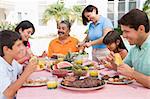 Family Enjoying A Barbeque