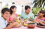 Family Enjoying A Barbeque