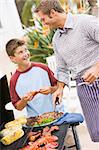 Father And Son Barbequing