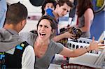 Frustrated young woman yells at a man in the laundromat